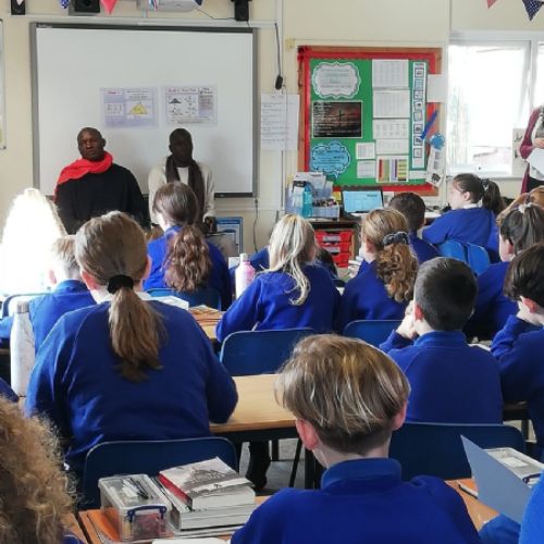 Ugandan visitors talk to Year 6